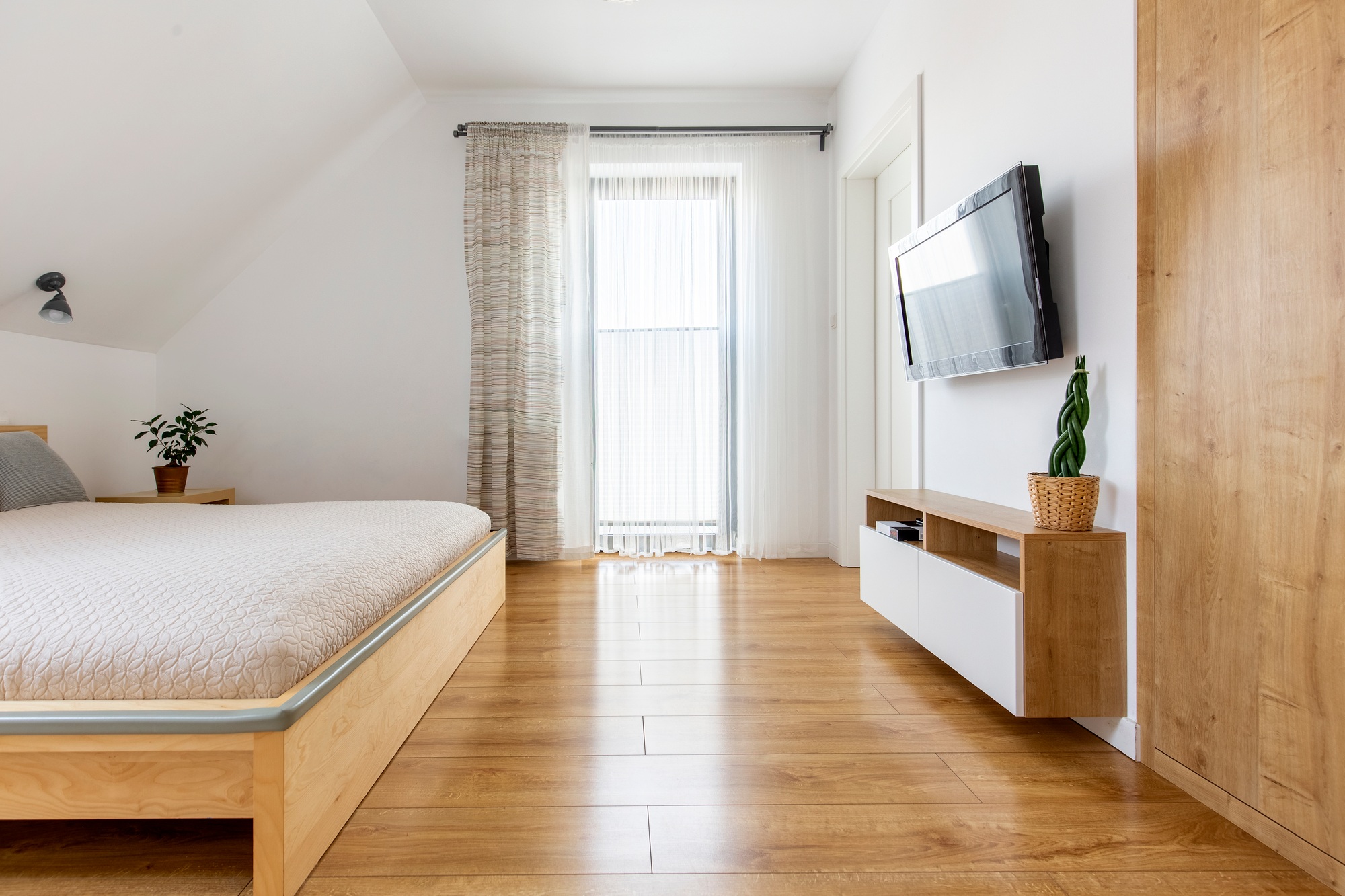 Real photo of a bright and spacious hotel bedroom interior with